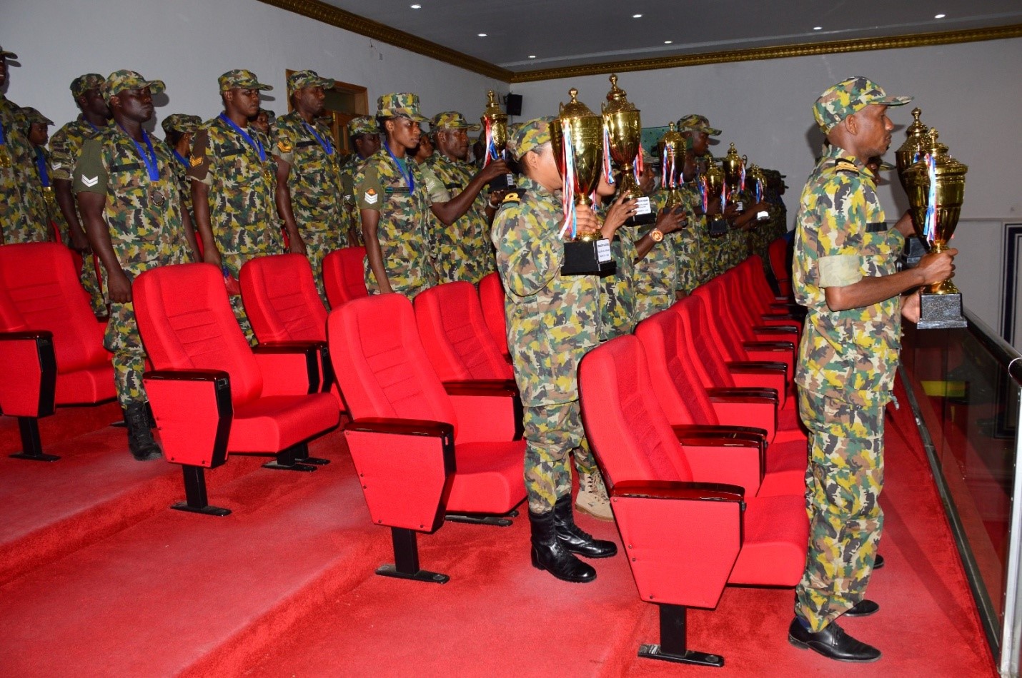 Baadhi ya Wanamichezo toka Kanda ya SMZ wakionyesha Viongozi wa  Baraza la Wawakilishi Vikombe walivyoshinda katika Michezo ya Majeshi (BAMMATA)